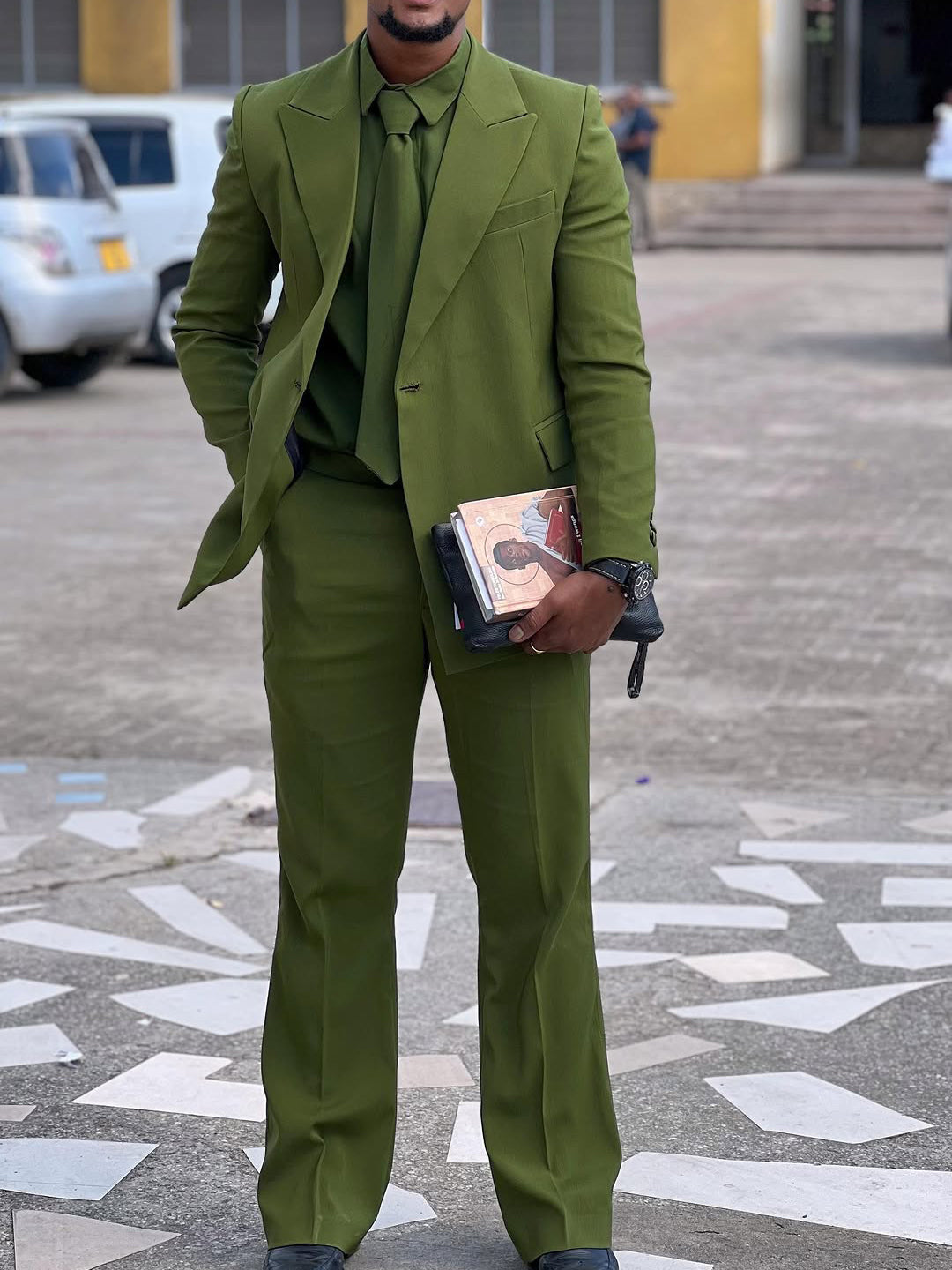 Olive- Green Three-Piece Suit Blaze&Shirt&Tie Ensemble styled on a man holding a book.