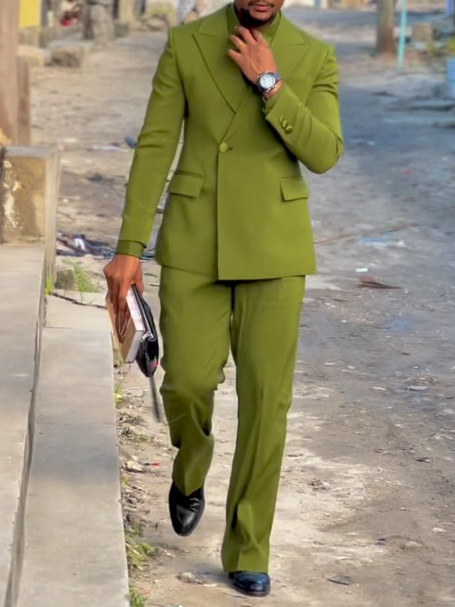 Olive- Green Three-Piece Suit Blaze&Shirt&Tie Ensemble worn by a man walking confidently on the street.